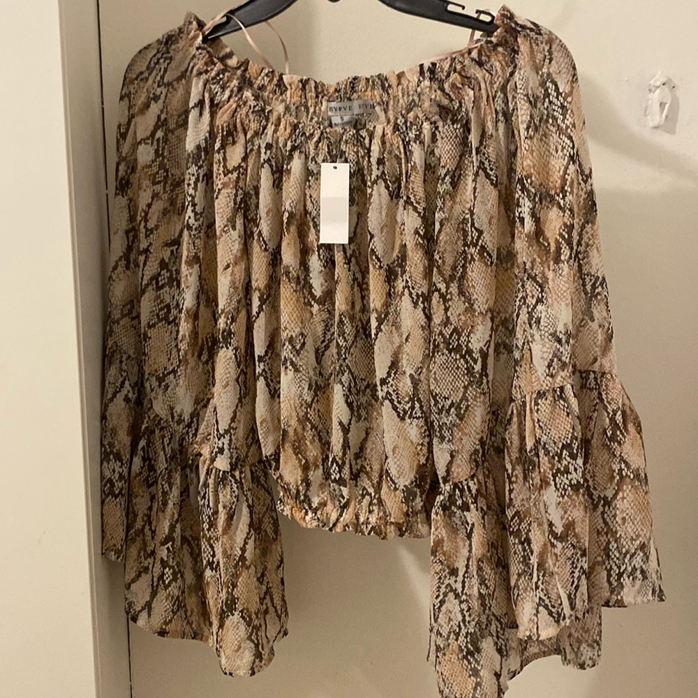 Off shoulder, snake skin, loose fit, sleeves are flared.